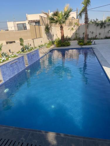 a large swimming pool with blue water at Deadsea Elite second floor shared swimming pool in Sowayma