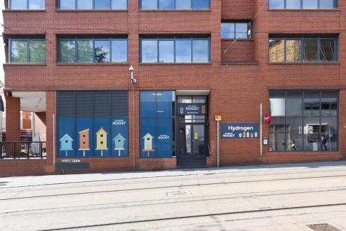 a brick building with a window with houses in it at Hydrogen in Nottingham in Nottingham