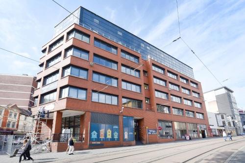 a tall brick building with people walking in front of it at Hydrogen in Nottingham in Nottingham