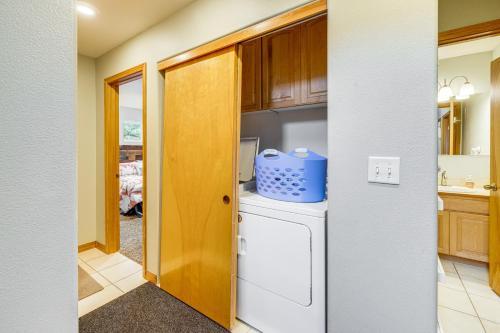 a kitchen with a washer and dryer at Rockaway Beach Home with Hot Tub 4 Blocks to Beach! in Rockaway Beach
