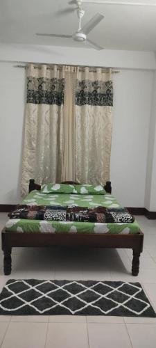 a bed sitting in a room with a window at Primrose Homestay in Guwahati