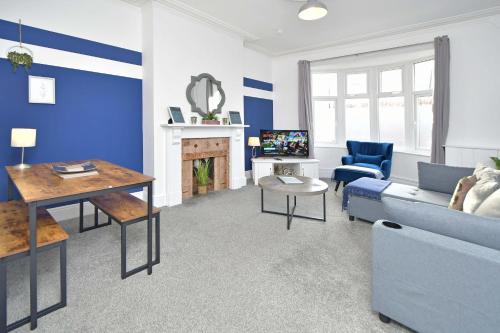 a living room with a couch and a table at Bentley House - By Sigma Stays in Crewe