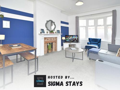 a living room with a couch and a table at Bentley House - By Sigma Stays in Crewe