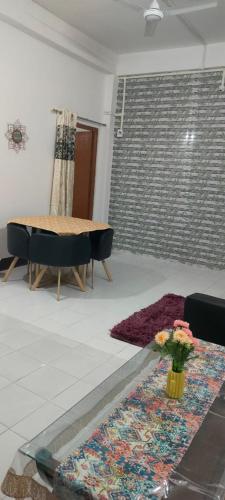 a living room with a table and a rug at Primrose Homestay in Guwahati
