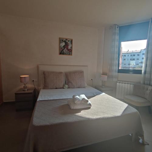 a bedroom with a bed with two towels on it at VILLAS COSETTE Apartamento CAMILLE in Sant Feliu de Guixols