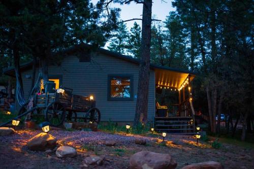 a house with lights in front of it at night at Peaceful Pine Place Cabin in Pine