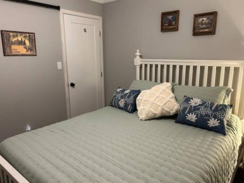 a bed with pillows on it in a bedroom at Peaceful Pine Place Cabin in Pine