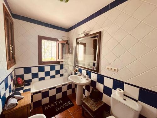 a bathroom with a sink and a tub and a toilet at Paraje del Almendral- Casa Grande in Lanjarón