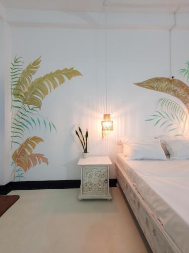 a bedroom with a bed and a nightstand with a table at Gypsea' Madiha in Matara