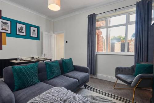 a living room with a couch and a window at Cosy 3-Bedroom House With Street Parking in Stockton-on-Tees