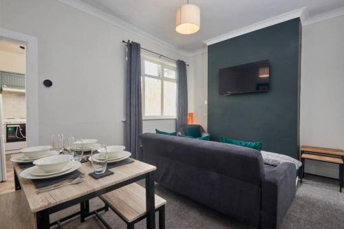 a living room with a couch and a table at Cosy 3-Bedroom House With Street Parking in Stockton-on-Tees