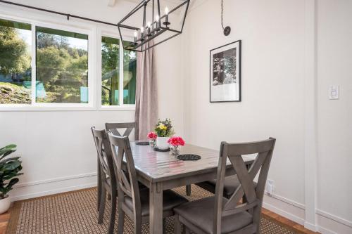 a dining room with a table and chairs at Buckeye Bungalow w hot tub/firepit/views Pet Friendly in Oakhurst