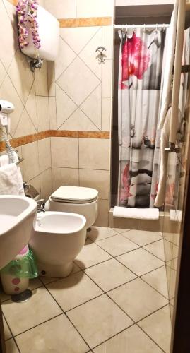 a bathroom with a toilet and a sink and a shower at B&B Ginevra 2 in Naples