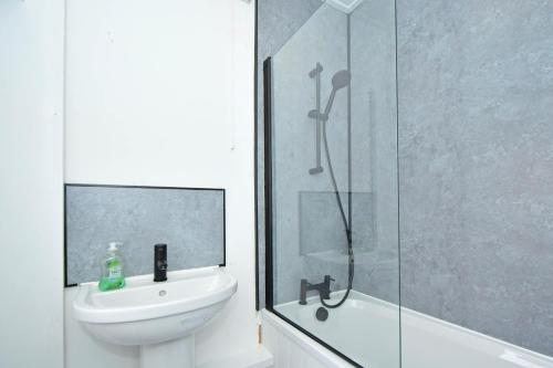 a bathroom with a shower and a sink and a toilet at Bentley Lofts - By Sigma Stays in Crewe