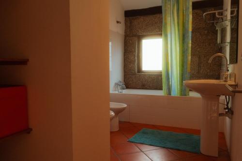 a bathroom with a sink and a toilet and a window at Cozy Family Home in Amazing Mountain with piano in Candemil