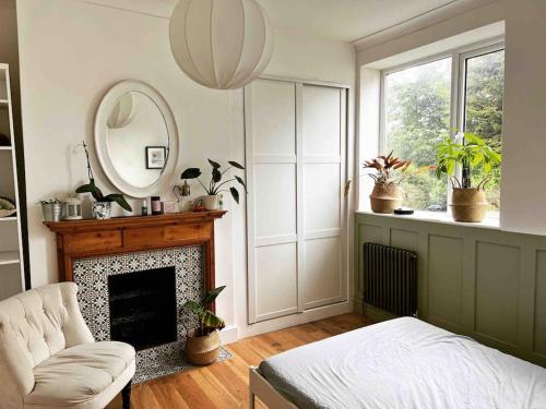 a living room with a fireplace and a mirror at Seashell Apartment - Central location in Kent