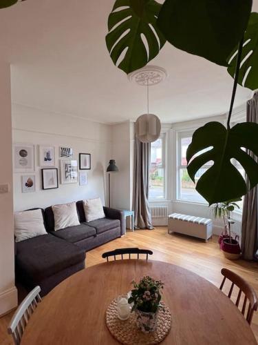 a living room with a table and a couch at Seashell Apartment - Central location in Folkestone