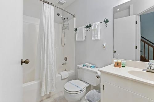 a white bathroom with a toilet and a sink at Laurelwood 73 with Wintergreen Advantage in Wintergreen