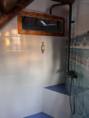 a bathroom with a shower with a shower head at The View of Zanzibar in Michamvi