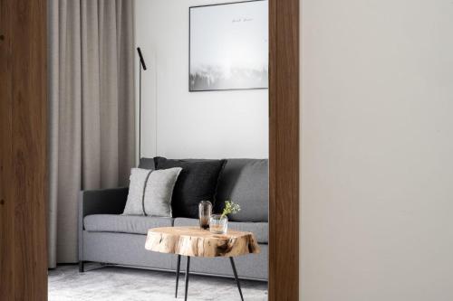 a living room with a couch and a table at Hotel ZAWRAT Ski Resort & Spa in Białka Tatrzanska
