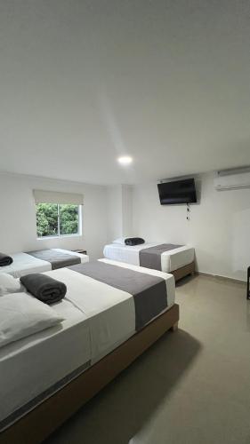 Postel nebo postele na pokoji v ubytování Hotel Medellín 66