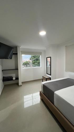 Postel nebo postele na pokoji v ubytování Hotel Medellín 66