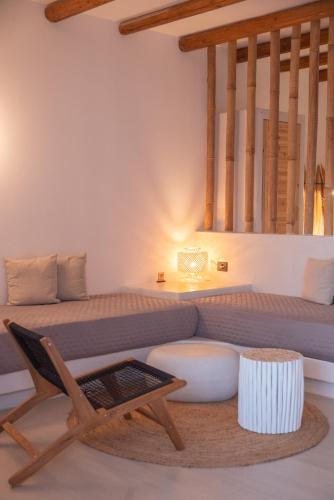 a living room with a couch and a chair at ARC suites in Mylopotas