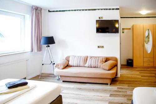 a living room with a couch and a television at Smart Resorts B&B 2 BB2 328 in Winterberg