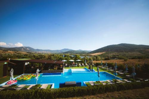 an overhead view of a swimming pool with a resort at Glamping&BeerSpa Scialla Sul Lago in Pignola