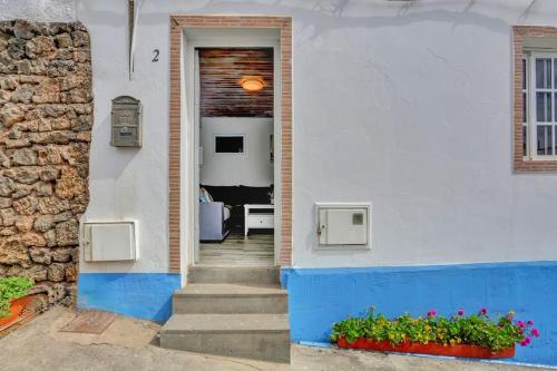 a white house with stairs leading to a door at Casa Vistamar comfy 4bd few steps to the ocean in Las Playas
