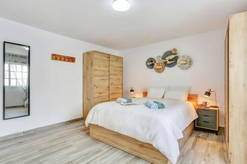 a bedroom with a large bed and a mirror at Casa Vistamar comfy 4bd few steps to the ocean in Las Playas