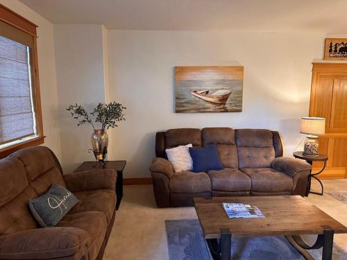 a living room with a couch and a table at Coeur d Alene Riverstone Retreat in Coeur d'Alene