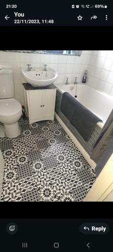 a bathroom with a tub and a sink and a toilet at Hertfordshire in Letchworth