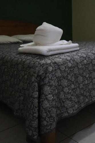 a pile of towels sitting on top of a bed at Hotel Toledo in David