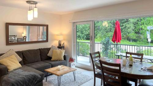 a living room with a couch and a table at Al's Escape by Revelstoke Vacations in Revelstoke