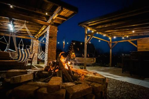 a fire pit in a patio at night at Cabana Masiv in Comăneşti