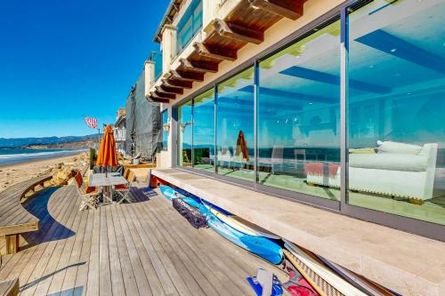 a house on the beach with large glass windows at Breakers Way Adventure in Carpinteria