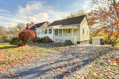 a white house with a driveway in front of it at Game Room and Fire Pit West Mifflin Home! in West Mifflin