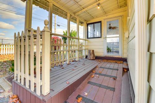 a porch of a house with a white fence at Game Room and Fire Pit West Mifflin Home! in West Mifflin