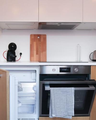 a kitchen with an oven with its door open at 1 bedroom apartment in Liège center - 1st floor in Liège