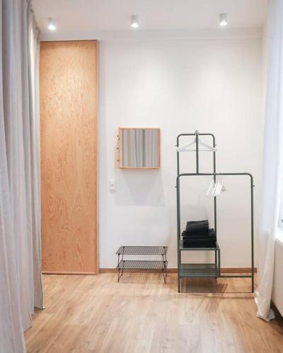 a room with a door and a bench next to a wall at 1 bedroom apartment in Liège center - 1st floor in Liège