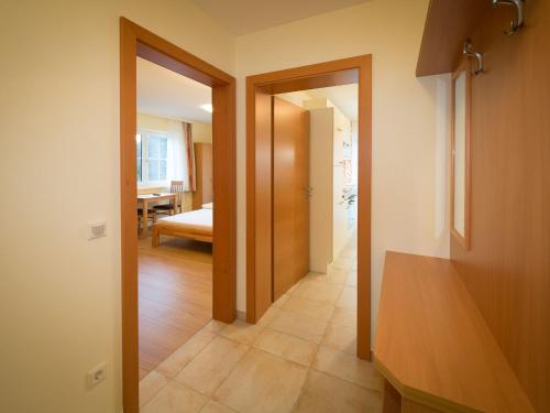 a hallway with a door leading to a bedroom at Alpengasthof Draxler in Forstau
