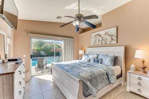a bedroom with a bed and a ceiling fan at Heated Pool at 3 BR Home 5 Mi to Coachella! in La Quinta