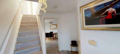 a stairway with a painting on the wall and a stair case at Sunderland Villa Luxuria 3 bedroom 3 Toilets Detached House in Sunderland