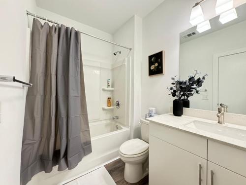 a white bathroom with a toilet and a sink at Luxury 1B1B with Balcony Downtown 542Blvd302 in Atlanta