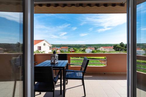 a table and chairs on a balcony with a view at MY DALMATIA - Sea view apartment Nika with private parking in Posedarje