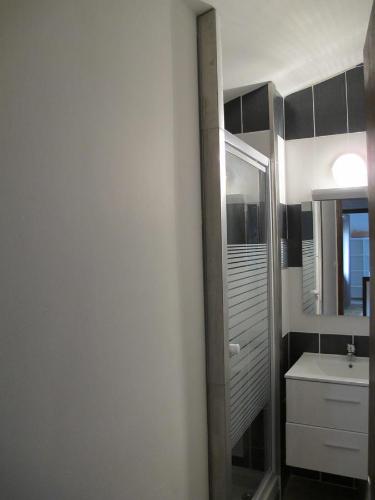 a bathroom with a sink and a mirror at Cairenou Location in Saint-Martin-dʼArdèche