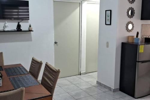 eine Küche und ein Esszimmer mit einem Tisch und einem Kühlschrank in der Unterkunft Alojamiento cómodo en Lomas de San Isidro in Culiacán Rosales