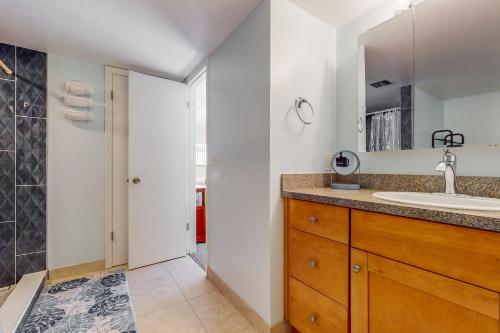 a bathroom with a sink and a mirror at Casa Flamingo in Cocoa Beach