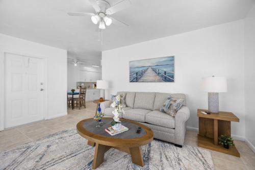 a living room with a couch and a table at Sunset Inn - Hallandale Beach in Hallandale Beach